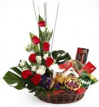 Basket arrangement of roses and 10 assorted bars of chocolates